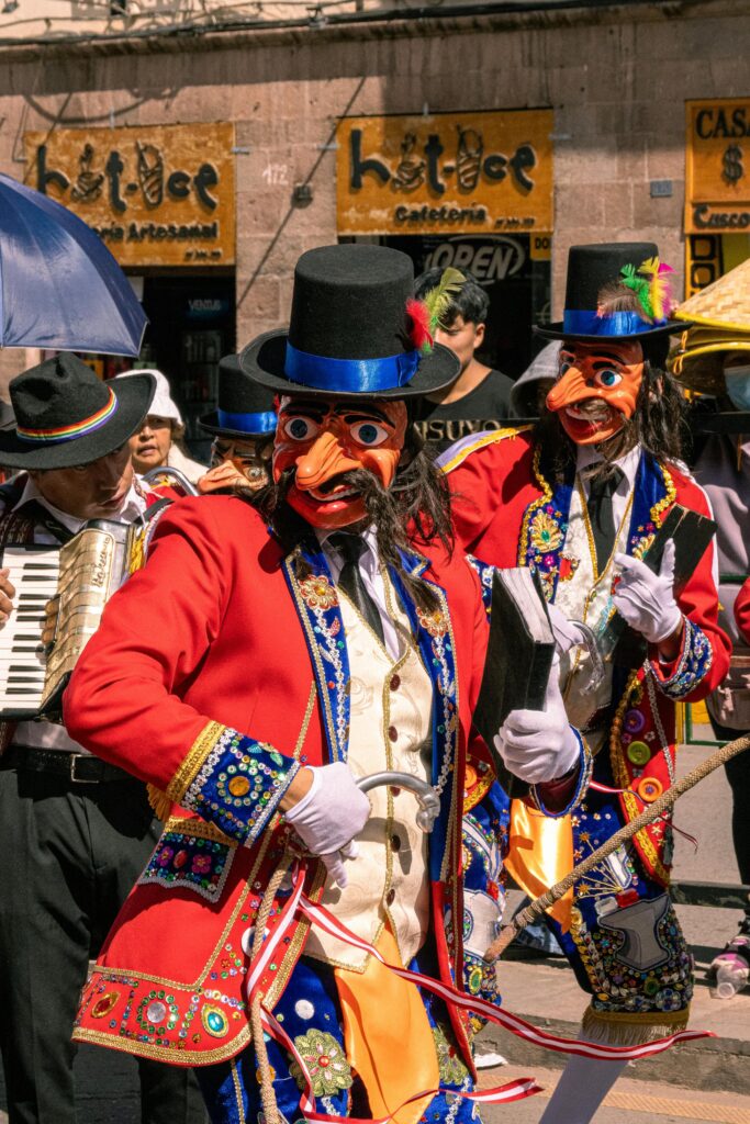 free photo of two men in colorful costumes and masks are playing instruments